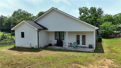 Rear view of property featuring a patio and french doors