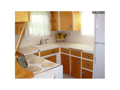 Retro economy kitchen with stove and refrigerator.
