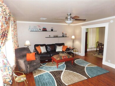 Living room showcases beautiful wood floors which 