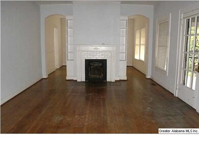 Living room with fireplace and hardwood floors.