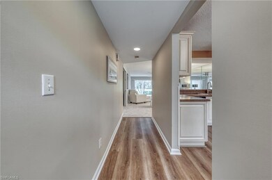 Hallway with sink and light hardwood / wood-style 