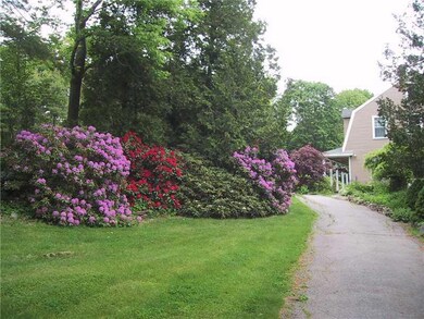 Exterior Front. Cedar hedge and...