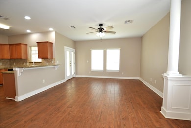 Unfurnished living room featuring ornate columns,