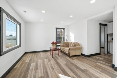 Living area featuring recessed lighting, plenty of natural light, and light wood-style floors