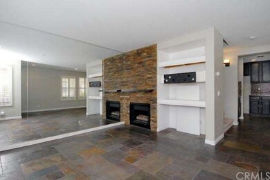 Living Room has Stacked Rock Fireplace and Flat Sc