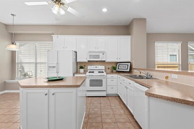 The kitchen has cabinets galore, tons of counter space, a large pantry and a breakfast area with a window seat.
