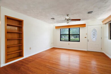 The front living room has large windows and built-