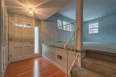 Welcoming foyer with large coat closets.