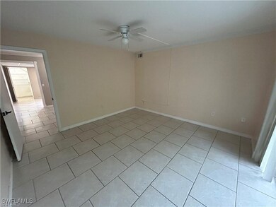 Empty room with light tile patterned flooring and