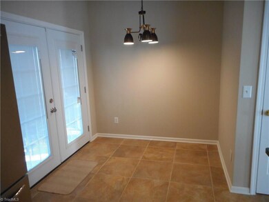 Eat in Kitchen Area: Here we have 20 inch tile flooring for easy cleaning, patio doors to the backyard and patio area. kitchen is behind us and the pantry is over to the right side.