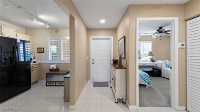 Entrance foyer featuring a ceiling fan, baseboards