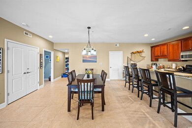 Dining space with light tile patterned flooring