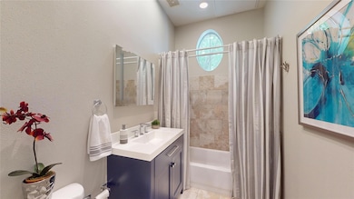 Full bath featuring shower / tub combo and vanity