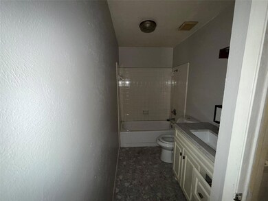Bathroom with toilet, vanity, shower / tub combina