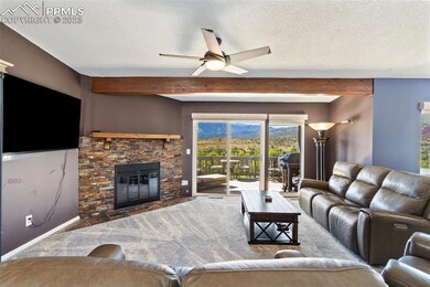 Living Room with beamed ceilings, fireplace, and p
