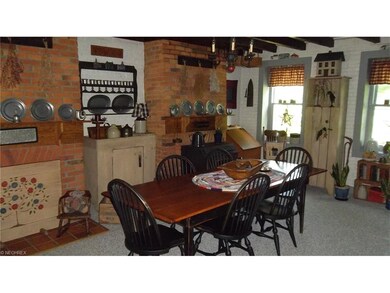 Dining room with original brick walls and wood bur