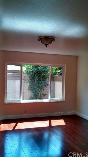 Another view of living room.  3 panel window overl