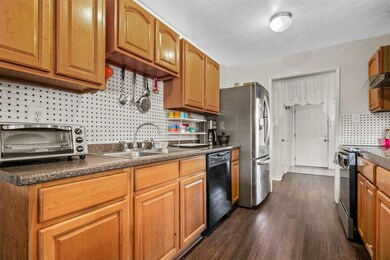 Kitchen with wall chimney range hood, a textured c