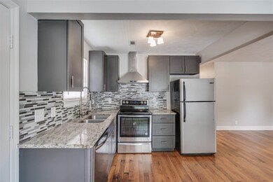 Newly updated kitchen with gleaming countertops.
