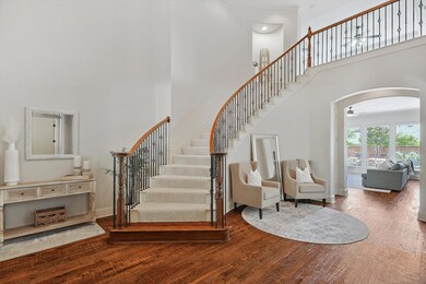 Stairway featuring a high ceiling and hardwood / w