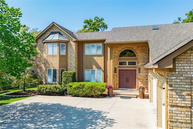 View of front of house featuring brick siding and roof with shingles