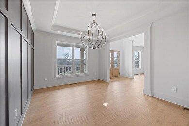 Unfurnished dining area featuring visible vents, b