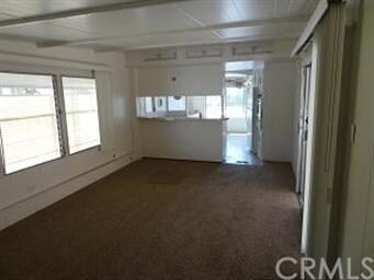 View of living room and kitchen. New carpet and fr