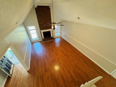 Unfurnished living room featuring a brick fireplac