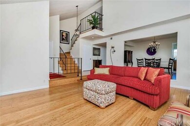Dramatic Stairway and Open Dining Room