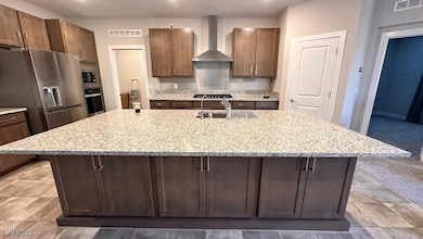 Kitchen featuring visible vents, wall chimney rang