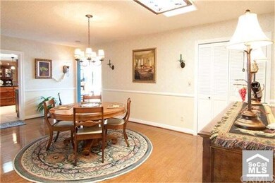 In Dining Room Hardwood Floors, Skylight, and Wine