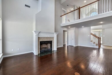 Open floorplan with soarling ceilings and fresh neutral paint.