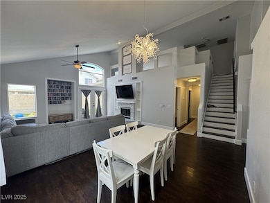 Dining space with a stone fireplace, visible vents