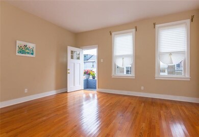 Huge living room with newer hardwood floors (2015) and multi-pane windows that let in lots of light!