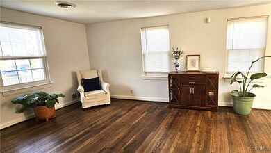 Living area featuring dark wood-type flooring, vis