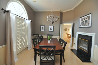 The dining room shares a double sided fireplace wi