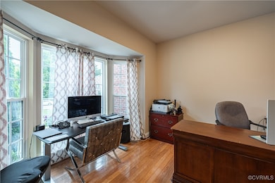 Office area with light wood-style floors, plenty o