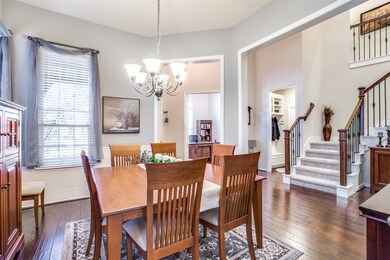 Another view of the formal dining, study and entrance into the home.  Notice the wood railing with wrought iron spindles on the stairway.