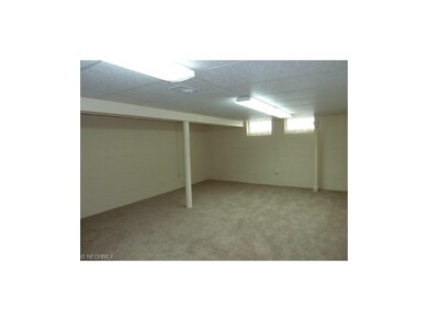 Finished basement drop ceiling, fluorescent lighting, newer carpeting, tasteful wall paint, basement waterproofed
