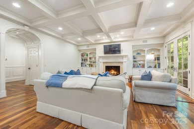 Coffered ceilings in the Open-Concept Living Room connected to the deck and kitchen. Brazilian Walnut Floors throughout the Main level.