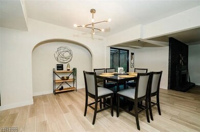 Dining space with a chandelier, light wood finishe