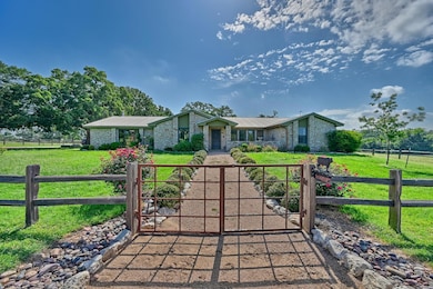 Mid-century inspired home with a gate, brick sidi