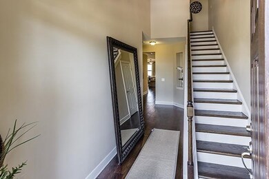 Stairway off the entrance in a similar home.