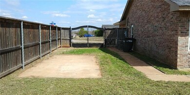 Gated backyard access with RV pad, sidewalks.