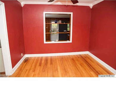 Formal Dining with crown moulding and window into the family room.