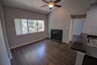 Unfurnished living room featuring a ceiling fan, 