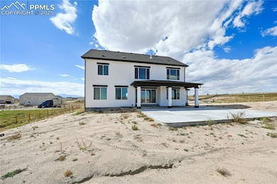 Back of property with a patio area and stucco siding
