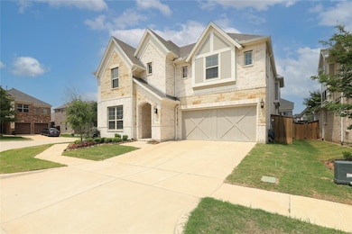 View of front facade with a front yard and a garage
