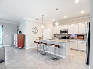 Kitchen featuring white cabinetry, appliances with