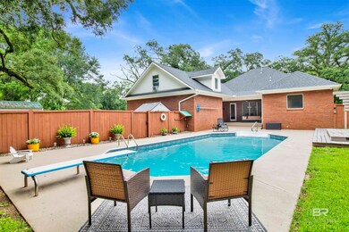 View of swimming pool featuring a patio and a diving board
